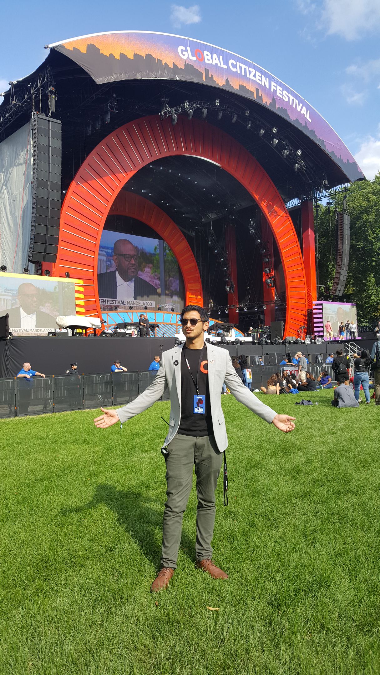 Man standing in front of a stage at the Global Citizen Festival