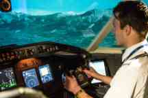 Aviation student pilots a plane in the aircraft simulator