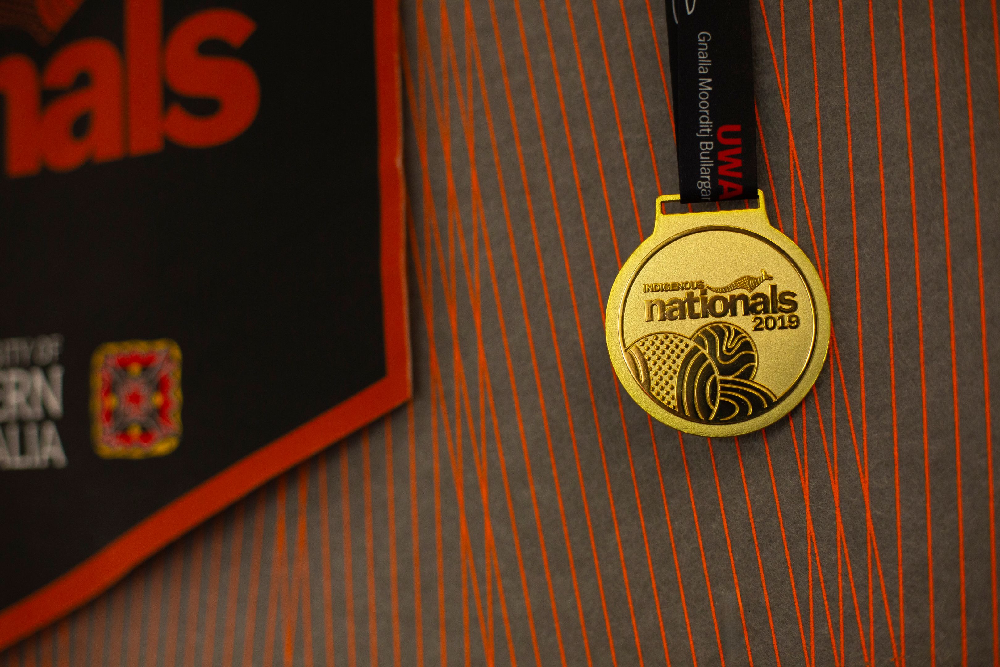A medal in the Indigenous Student Lounge from Swinburne's participation in the UniSport Indigenous Nationals Competition.