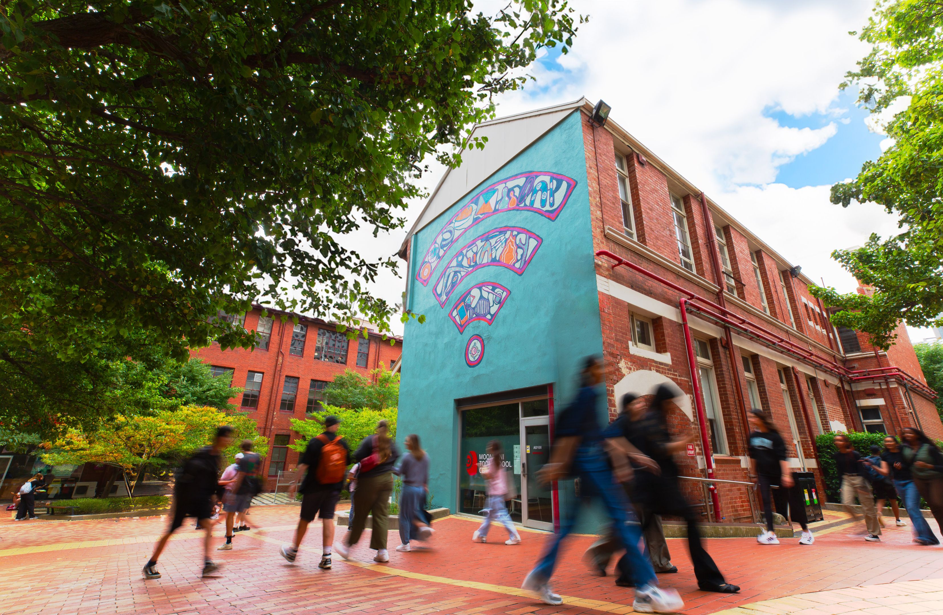 The exterior of the Moondani Toombadool Centre building on Swinburne's Hawthorn campus featuring mural by artist Mandi Barton