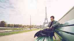 Businessman in Paris reading a book, Eiffel Tower