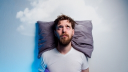 Man on a pillow unable to sleep