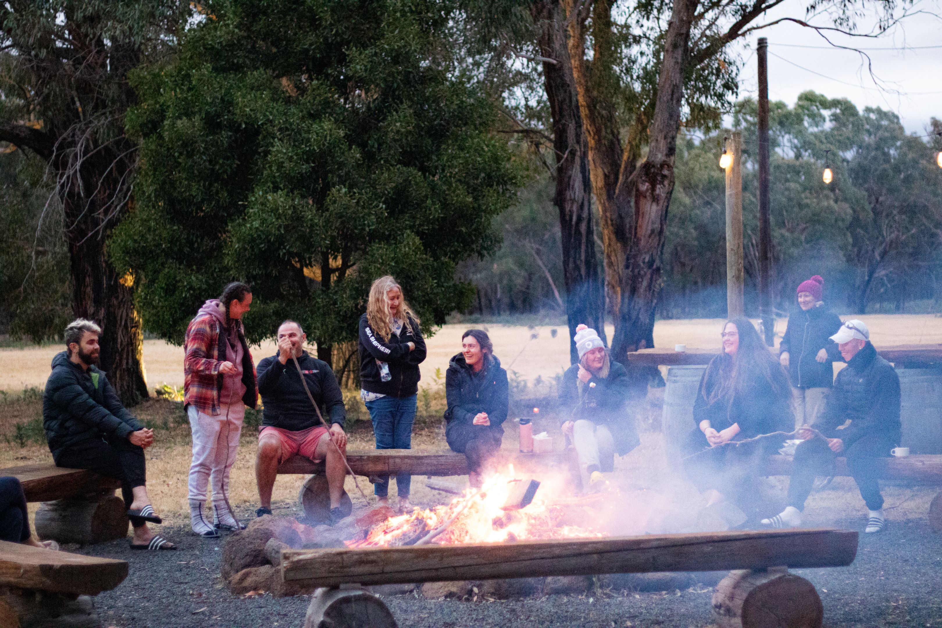 Indigenous students and MTC staff members around a bonfire during the MTC On-Country Development Program.